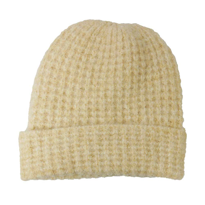 Beige knit beanie on a white background