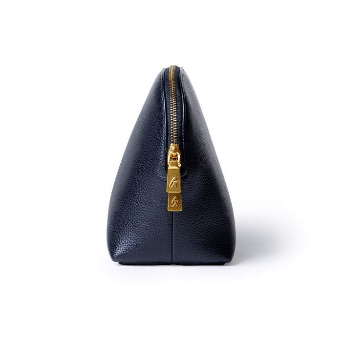 Black jumbo pebble-textured cosmetic pouch with a gold zipper and pull tab, standing upright against a white background.