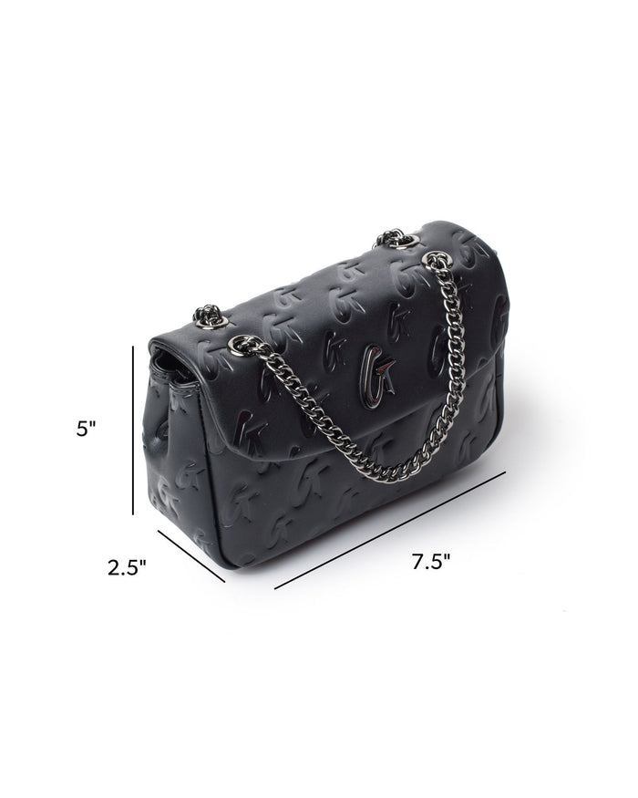 Mini Monogram Flap Bag in black featuring embossed logo design and silver chain strap, perfect for stylish outings.
