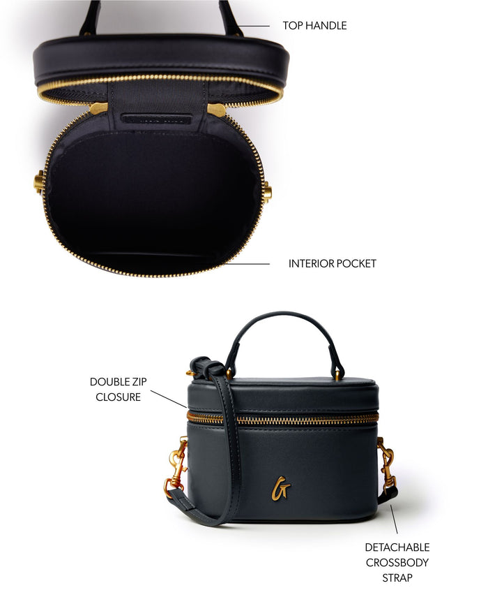 Mini smooth gold vanity bag in black with a top handle, double zip closure, and detachable crossbody strap.