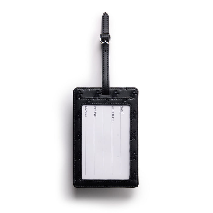 Black monogram luggage tag with a clear ID window and attached strap for secure travel identification.
