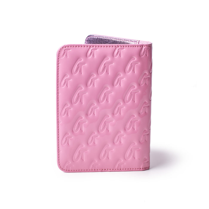 Mirror pink monogram passport holder with embossed G logo pattern and metallic interior, stylish travel accessory.