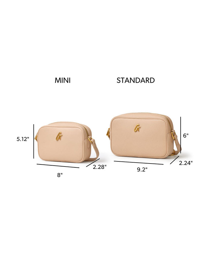 Nude standard pebble camera bag with gold hardware, featuring a spacious design for stylish storage.