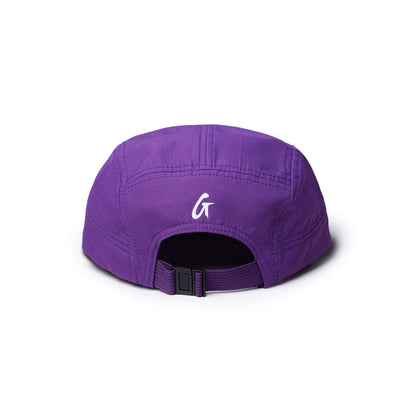 Back view of a purple athletic 5 panel hat featuring a white logo and an adjustable strap for a secure fit.