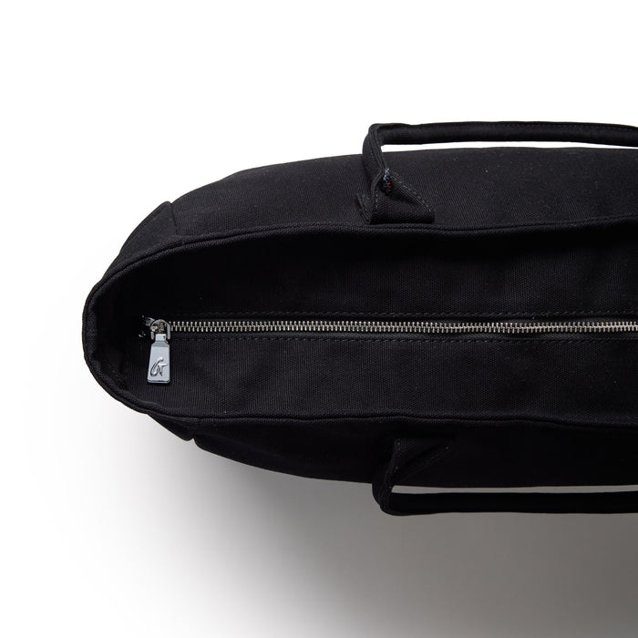Black athletic canvas tote bag with a zippered closure and sturdy handles, ideal for gym or everyday use.