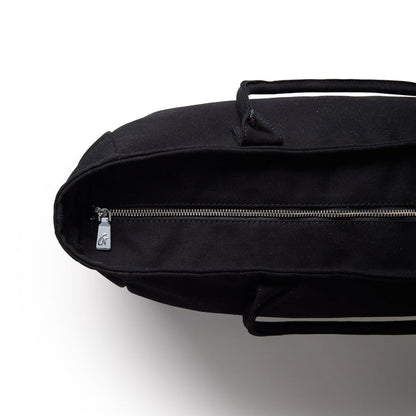 Black athletic canvas tote bag with a zippered closure and sturdy handles, ideal for gym or everyday use.