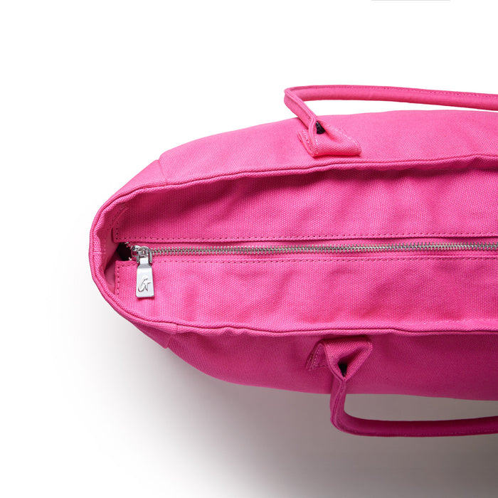 Hot pink athletic canvas tote bag featuring a zippered closure and sturdy handles for versatile use.
