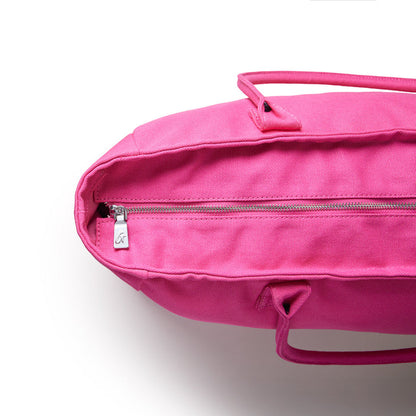 Hot pink athletic canvas tote bag featuring a zippered closure and sturdy handles for versatile use.