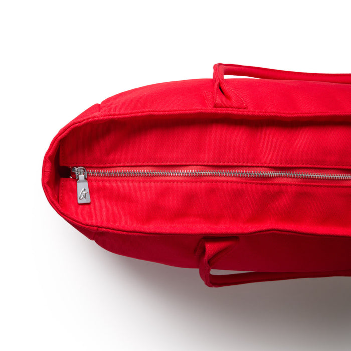 Red athletic canvas tote bag featuring a zippered closure and sturdy handles for easy carrying.