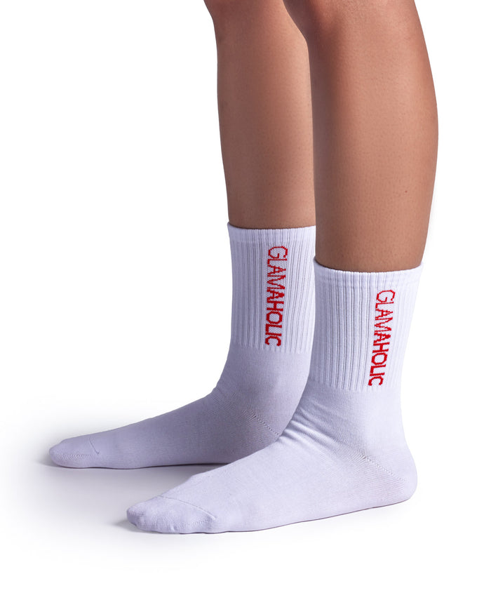 White athletic crew socks featuring red "Glam-Aholic" branding on the ribbed cuff, perfect for sports and casual wear.