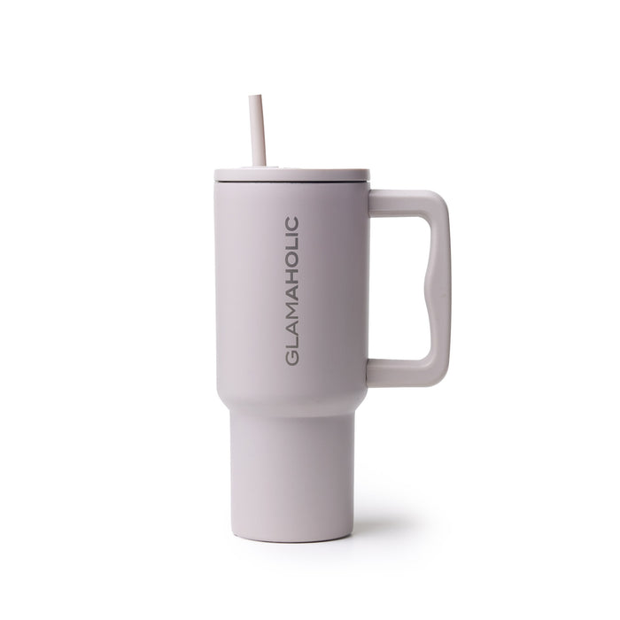 Nude athletic tumbler with a handle and straw, featuring the Glam-Aholic logo on the side.