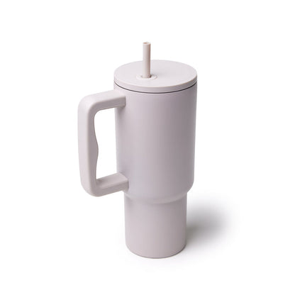 Nude athletic tumbler with a handle and straw, designed for easy sipping and on-the-go hydration.