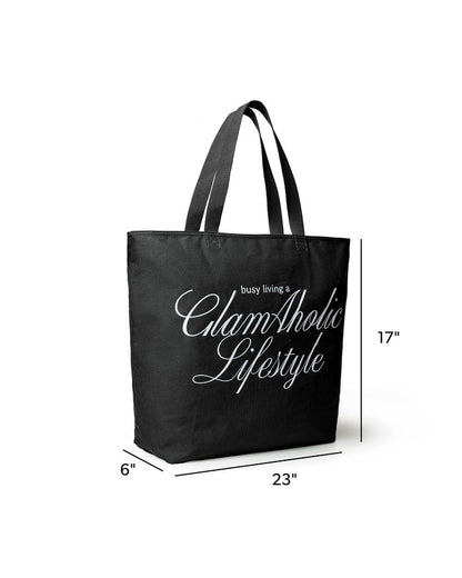 Black canvas tote bag featuring "Busy Living a GlamAholic Lifestyle" text, measuring 23 inches wide and 17 inches tall.