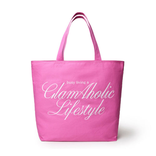 Hot pink canvas tote bag featuring the phrase "busy living a Glam-Aholic Lifestyle" in elegant white lettering.