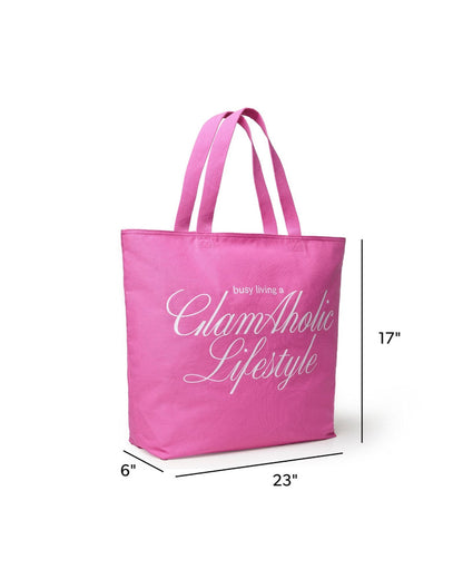 Hot pink canvas tote bag with "busy living a GlamAholic Lifestyle" printed in white, measuring 23 inches wide and 17 inches tall.