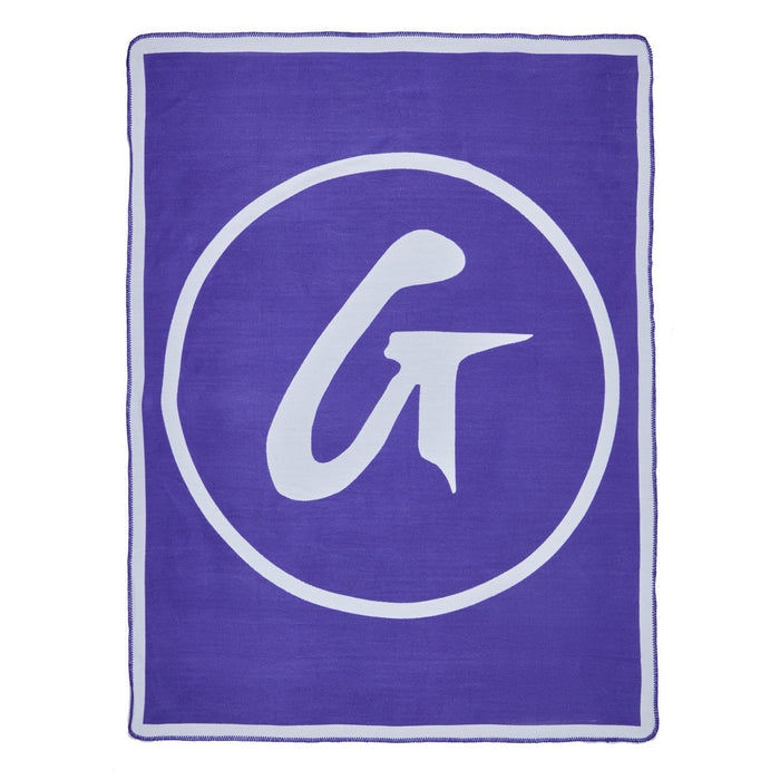 Purple throw blanket with a large white circular logo and stylized "G" design, soft and cozy for added warmth.