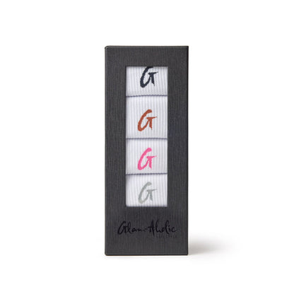 Set of four crew socks in white with colorful embroidered "G" logos in black, orange, pink, and gray, packaged in a black box.
