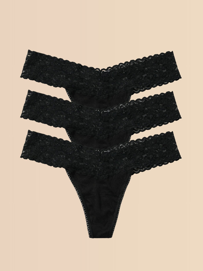 Black DreamEase™ Low Rise Thong 3-Pack Flat Lay on Cream - Lace Thongs | Hanky Panky