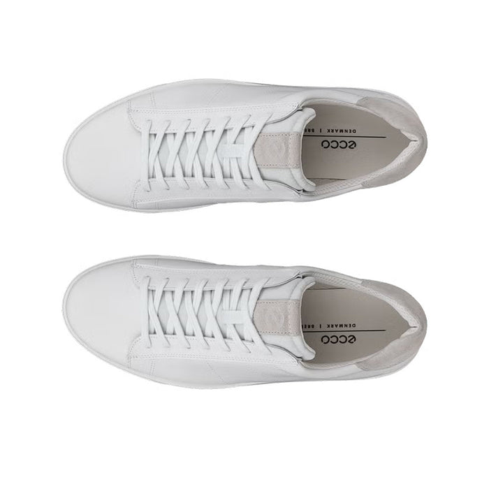 Pair of white leather sneakers showing laces and inner lining label area.