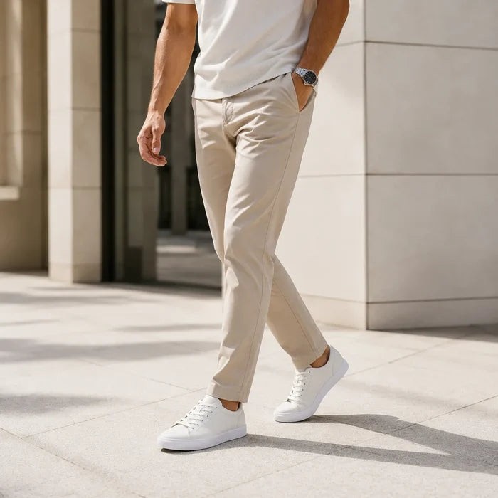Men's leather lace-up sneakers on model, white low-top with laces and white outsole