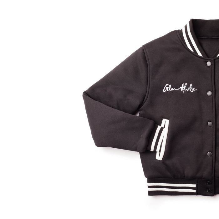 Black varsity jacket with striped cuffs, collar, and waistband, featuring embroidered "Glam-Holic" on the chest.