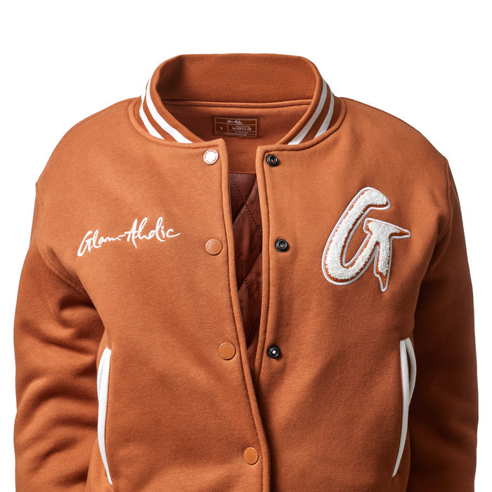 Brown varsity jacket with embroidered patches, white accents, and snap button closure, featuring a classic sporty style.
