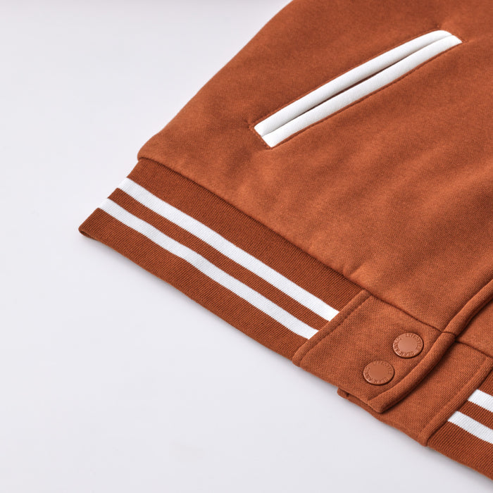 Brown varsity jacket with white striped cuffs and a white stripe detail on the pocket, featuring snap button closures.
