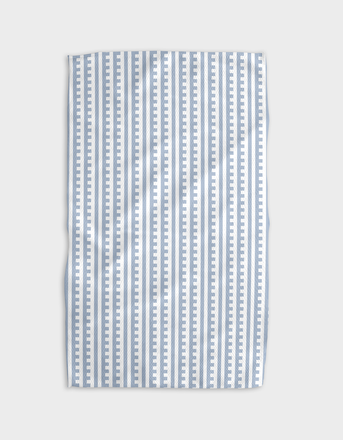 A blue and white striped tea towel with a solid pattern and a hang loop.