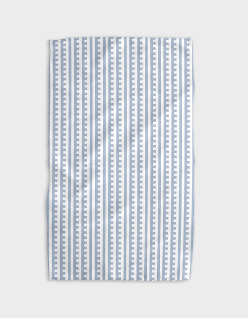 A blue and white striped tea towel with a solid pattern and a hang loop.
