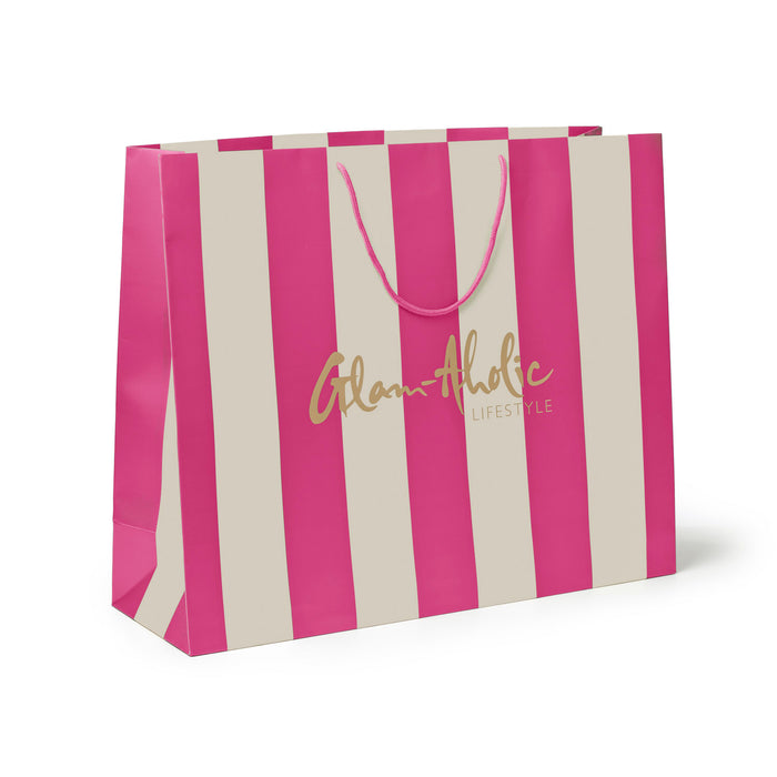 Large pink and cream striped gift bag with a stylish logo, perfect for elegant gifting and celebrations.