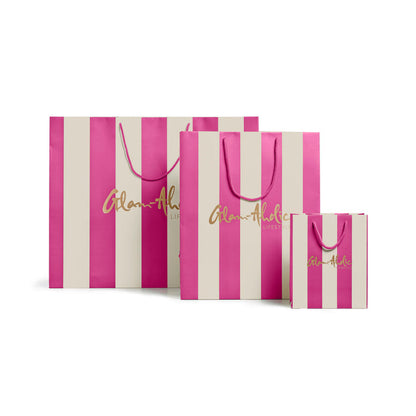Large pink and cream striped gift bags with Glam-Aholic Lifestyle branding, perfect for stylish gifting.