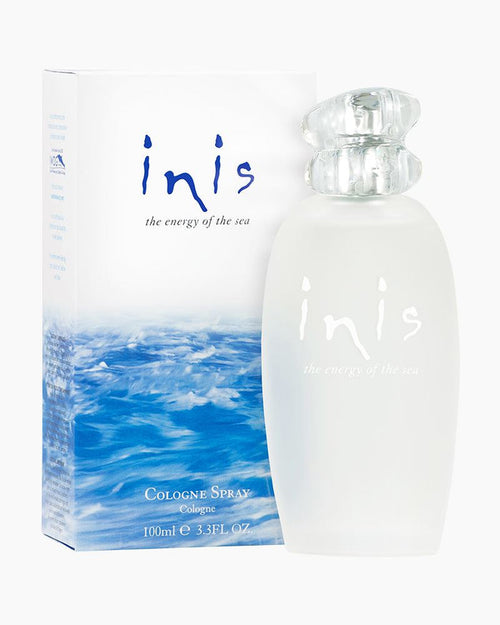 A bottle of Inis cologne with its packaging box. The bottle is transparent with a silver cap, and the box has a blue and white design with the Inis logo.