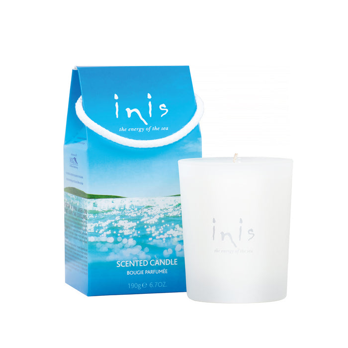 An Inis brand scented candle in a white frosted glass vessel, with a blue giftable box labeled 'Inis - The Energy of the Sea'.