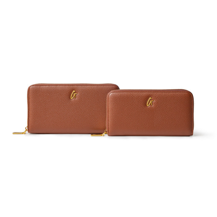 Brown jumbo pebble leather wallets with gold zipper and logo, featuring textured surface and spacious design.