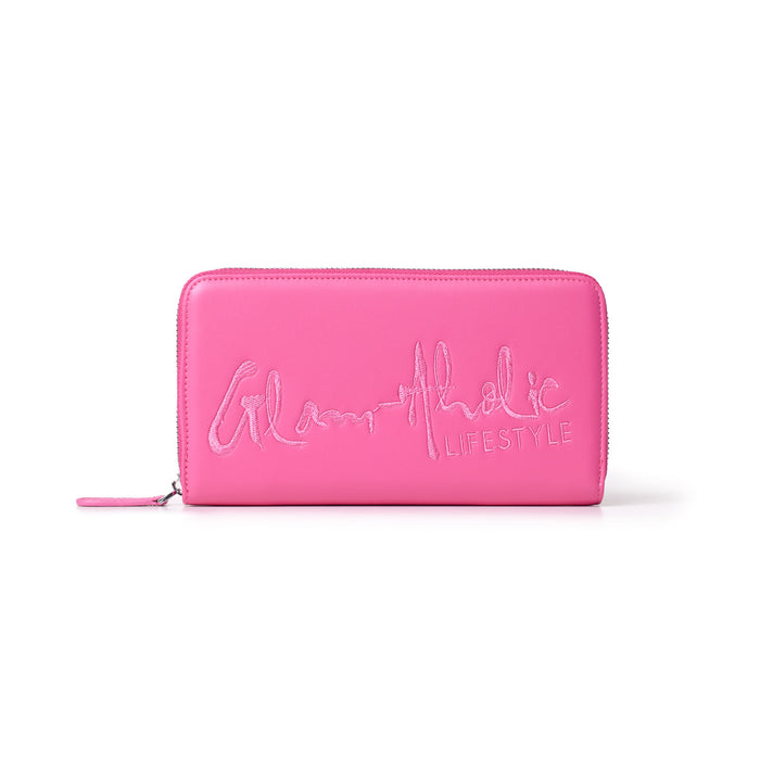 Hot pink wallet with a large signature logo and "LIFESTYLE" embroidered on the front, featuring a zipper closure.