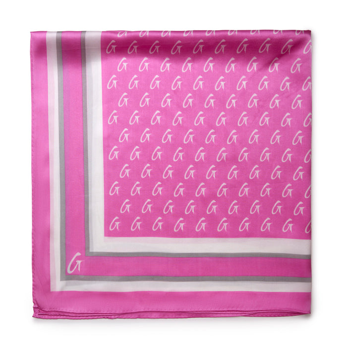 Large monogram silk scarf in soft pink featuring a repeating logo pattern and elegant border design.