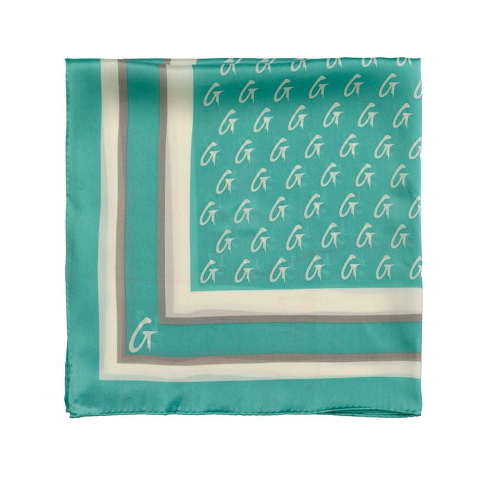 Teal large monogram silk scarf featuring a repeating logo pattern and elegant border design. Perfect for stylish layering.