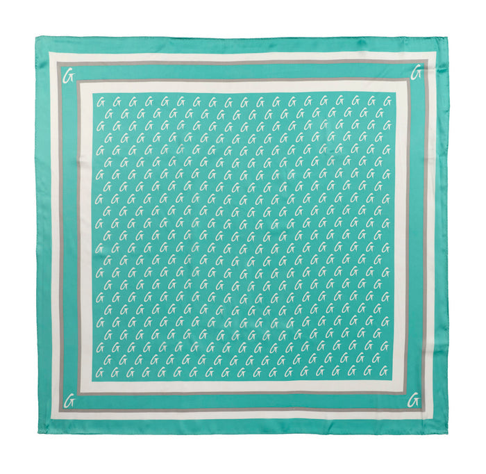 Teal large monogram silk scarf featuring a repeating logo pattern and a contrasting border design.
