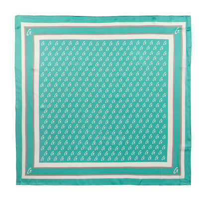 Teal large monogram silk scarf featuring a repeating logo pattern and a contrasting border design.