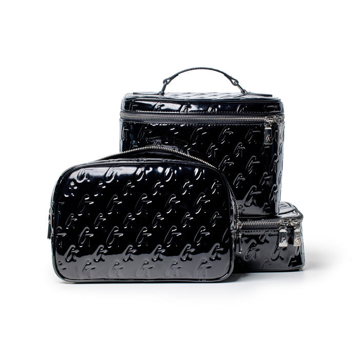 Black glossy monogram toiletry bag set with embossed logo pattern, featuring silver zippers and a handle, on a white background.