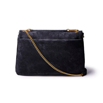 Large black suede flap bag with a gold chain strap, perfect for adding a touch of luxury to any outfit.