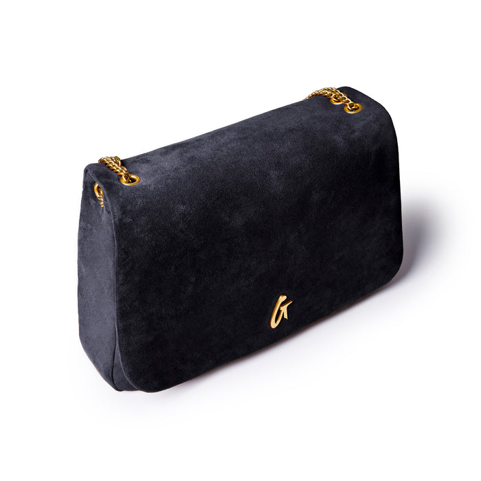 Large black suede flap bag with gold chain accents, offering a chic and luxurious style for any outfit.