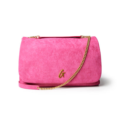 Large hot pink suede flap bag with a gold chain strap, perfect for adding a pop of color to any outfit.