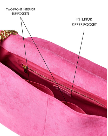 Large hot pink suede flap bag featuring an interior zipper pocket and two front slip pockets for organization.