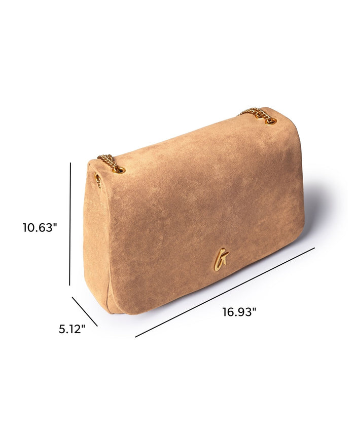 Large tan suede flap bag with a sleek design, featuring a gold logo and spacious interior for stylish organization.