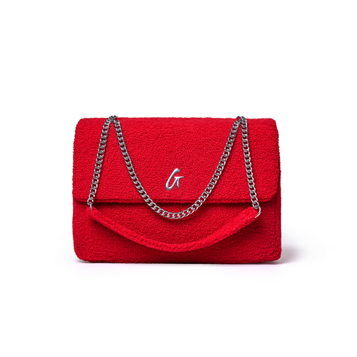 Large red teddy flap bag with a plush texture and silver chain straps, perfect for adding a pop of color to any outfit.