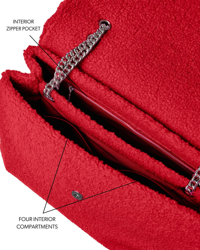 Large red teddy flap bag featuring an interior zipper pocket and four spacious compartments for organized storage.