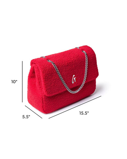 Large red teddy flap bag with a silver chain strap, featuring a stylish logo and plush texture.