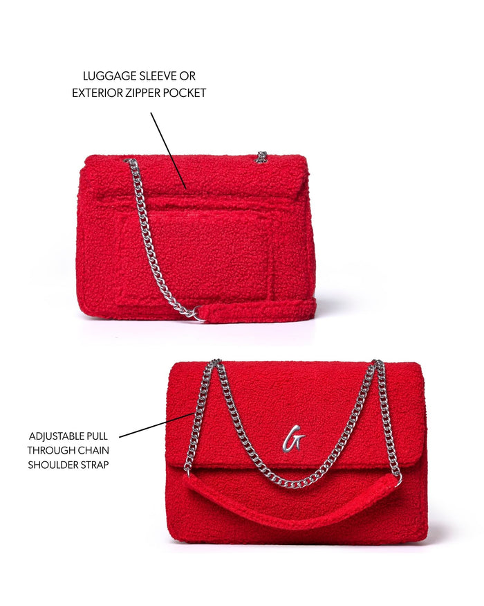 Red large teddy flap bag featuring a luggage sleeve, exterior zipper pocket, and adjustable chain shoulder strap.