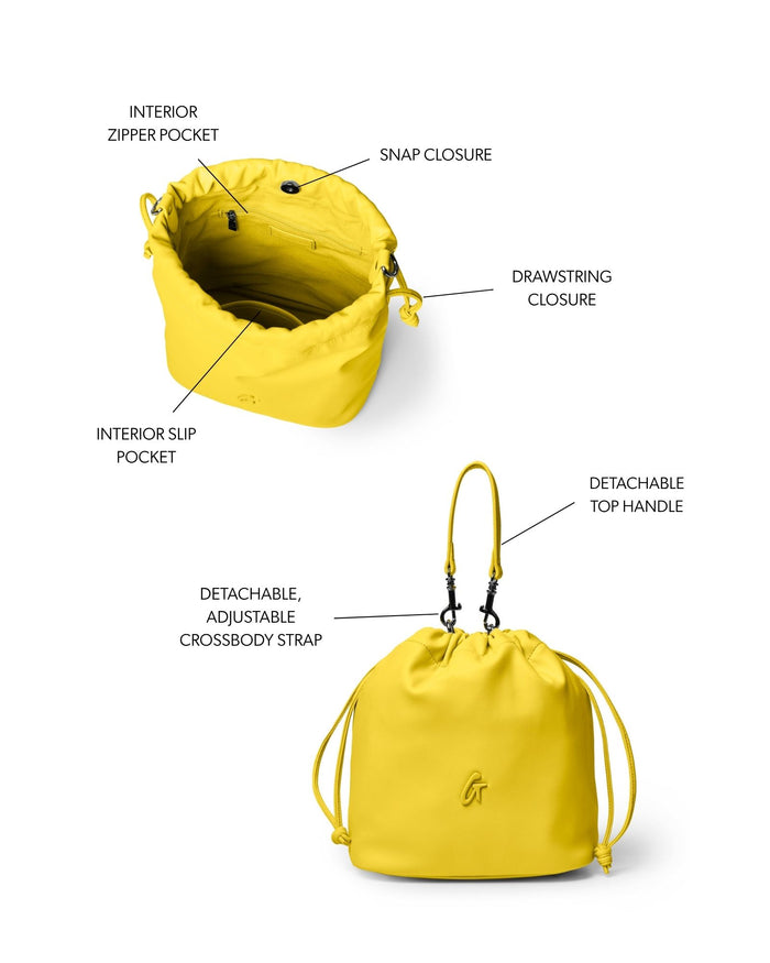 Medium yellow drawstring bucket bag featuring a snap closure, interior zipper pocket, and detachable crossbody strap.
